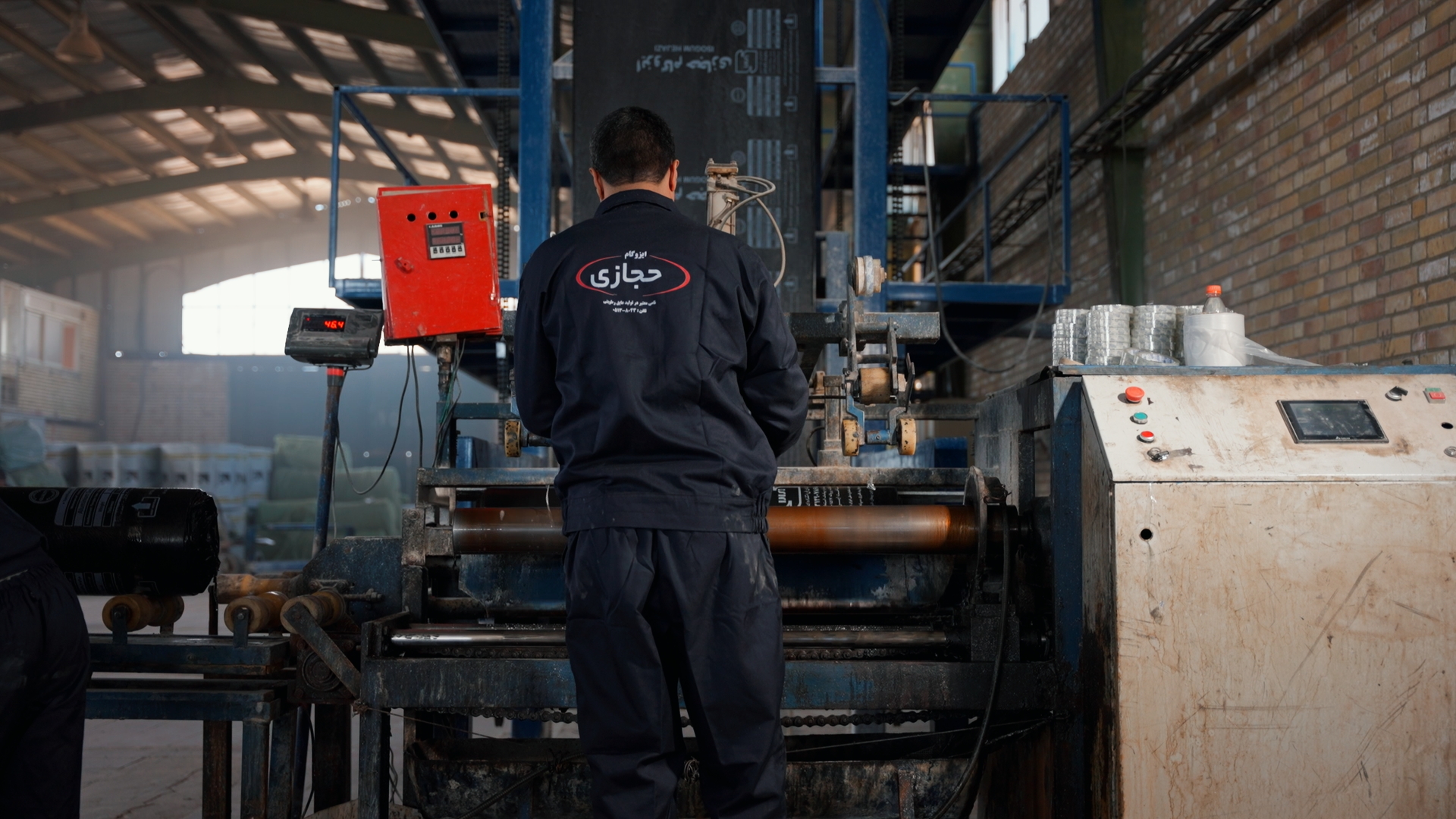 Factory operator working with production equipment